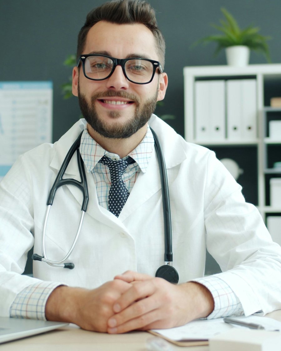 A specialist reviewing a patient's case at his desk